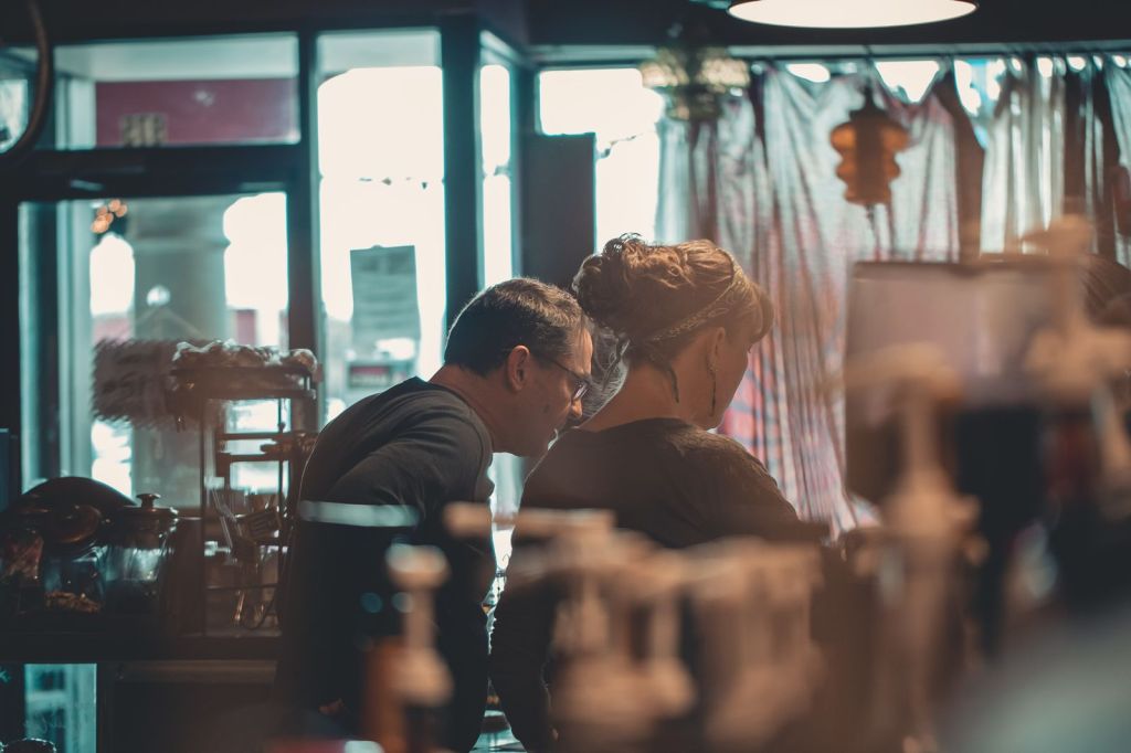 Two small-business owners talking in a cafe