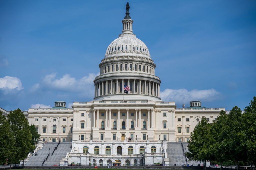 Front view of the U.S. Capitol building in Washington under a blue sky