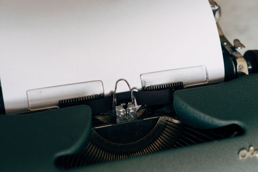 A blank sheet of paper loaded in a classic typewriter