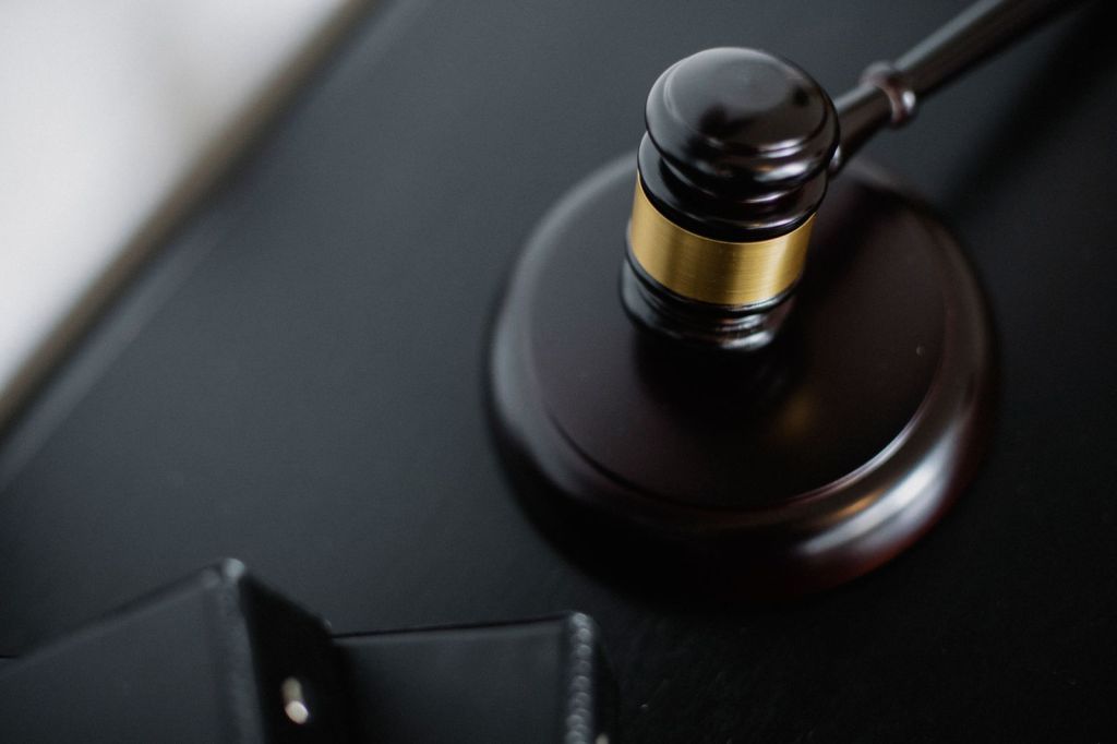 Close-up of a wooden judge's gavel resting on its block